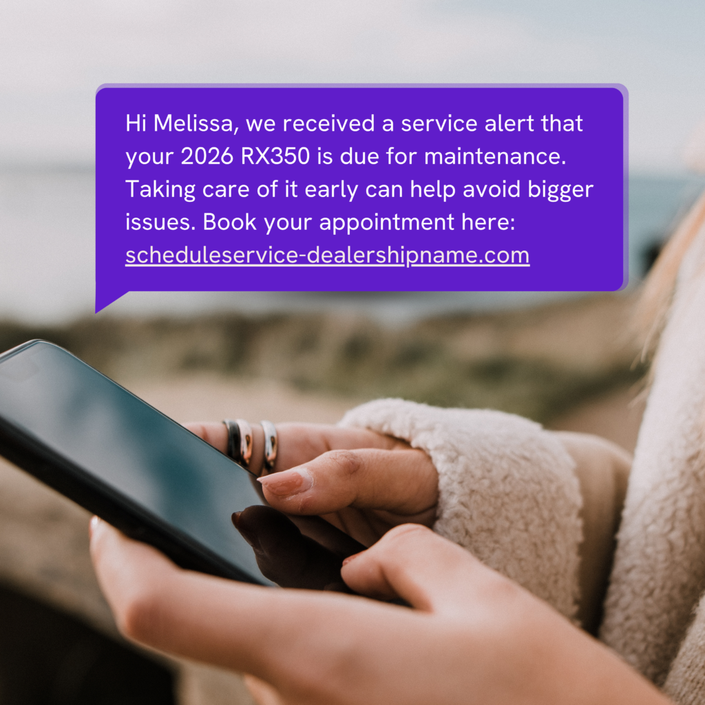 Close-up of hands with rings holding a smartphone, a purple notification bubble on the screen, with a blurred outdoor background.