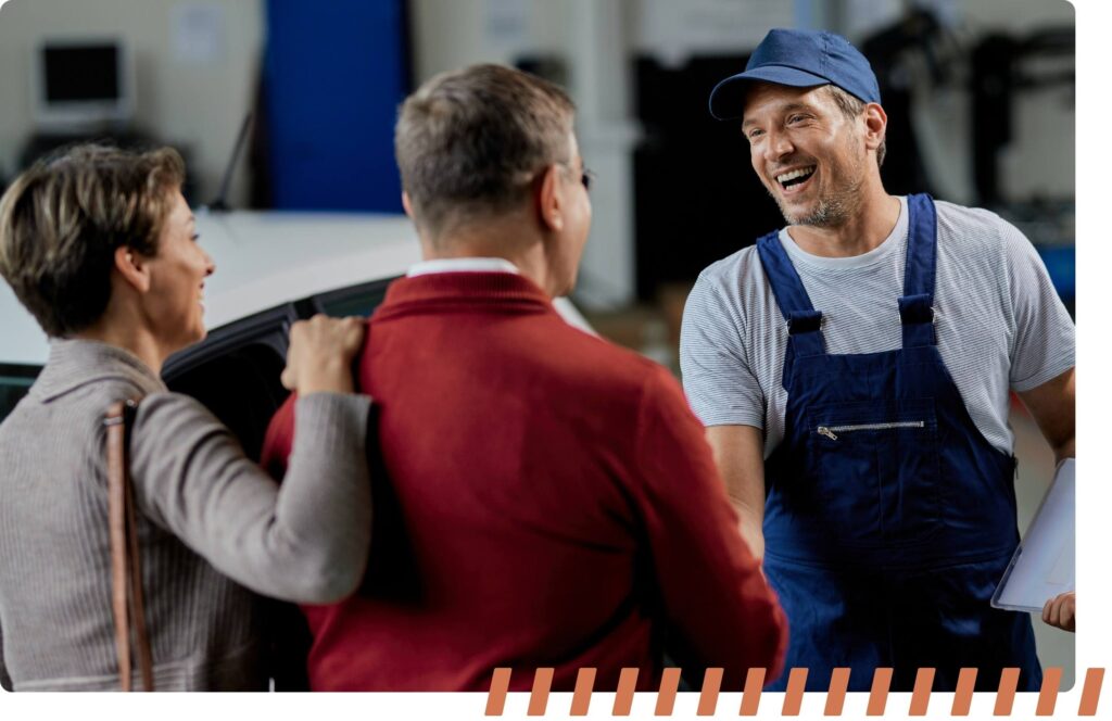 car dealership service person shaking hands of customer